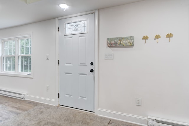 foyer entrance featuring light wood-type flooring and baseboard heating