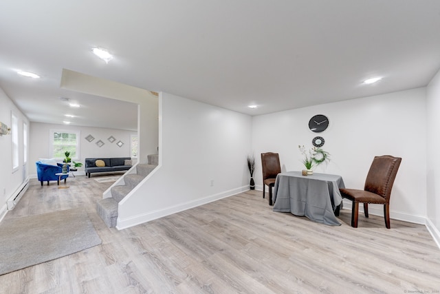 living area with light hardwood / wood-style floors and a baseboard radiator