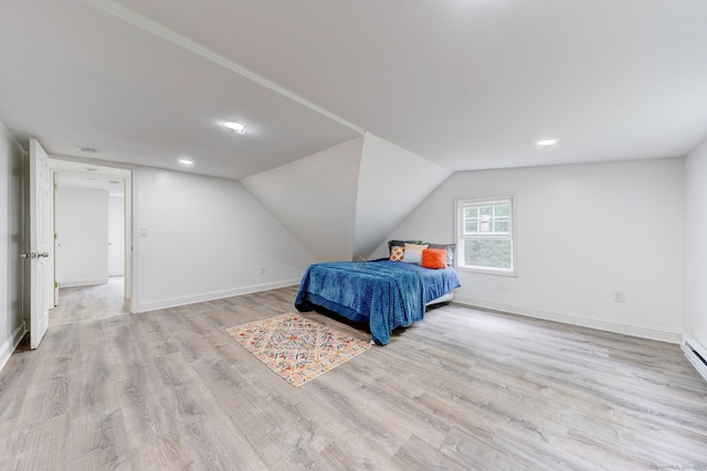 bedroom featuring vaulted ceiling and light hardwood / wood-style flooring