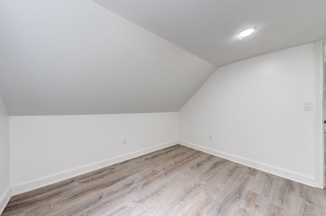 bonus room featuring light hardwood / wood-style flooring and lofted ceiling