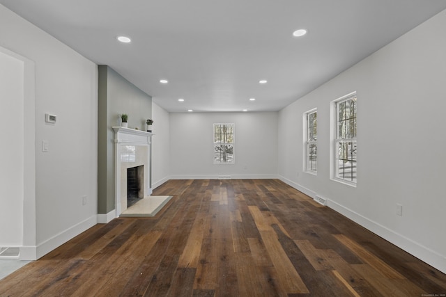 unfurnished living room with dark hardwood / wood-style floors