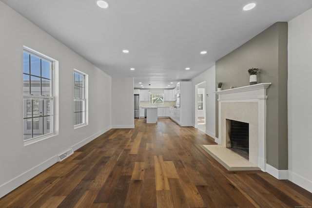 unfurnished living room featuring dark hardwood / wood-style flooring