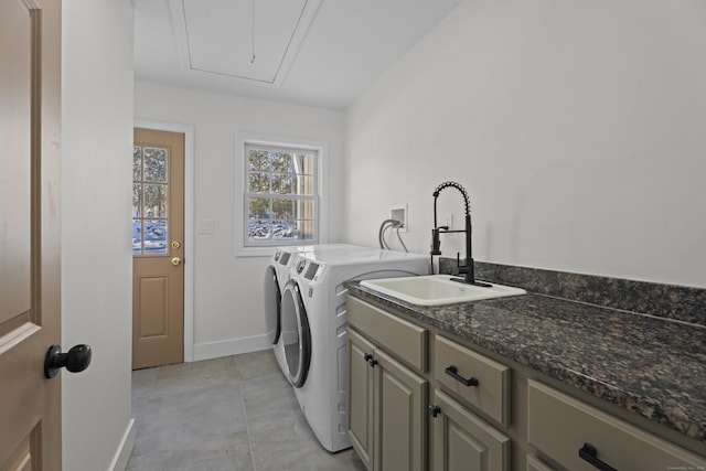 clothes washing area with cabinets, washing machine and clothes dryer, sink, and light tile patterned floors