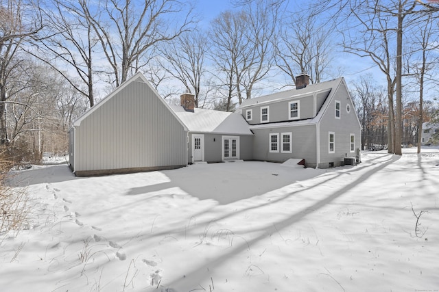 snow covered property with cooling unit