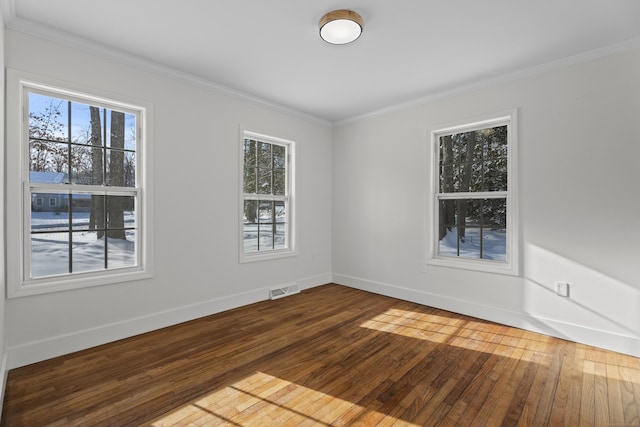 spare room featuring hardwood / wood-style flooring and ornamental molding