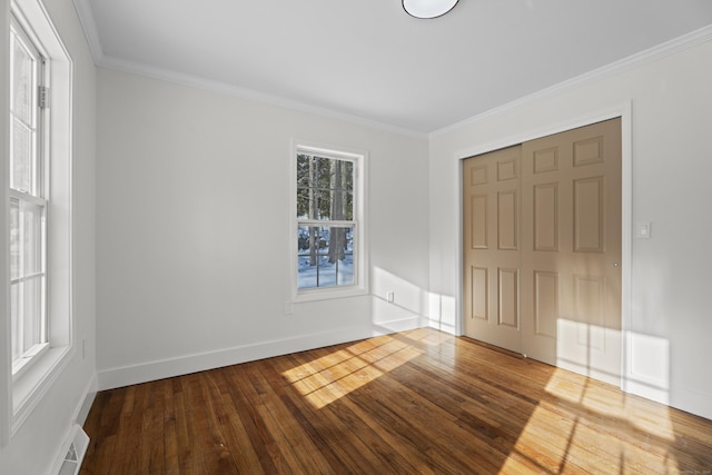 interior space with ornamental molding and hardwood / wood-style floors