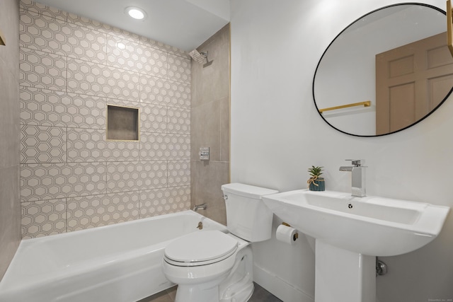 bathroom featuring tiled shower / bath and toilet