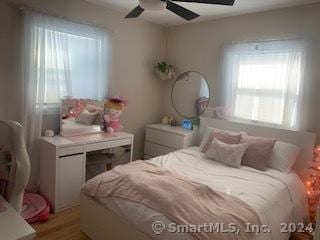 bedroom featuring light hardwood / wood-style flooring and ceiling fan