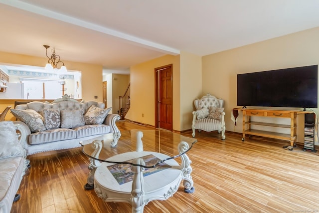 living room featuring wood finished floors and stairway