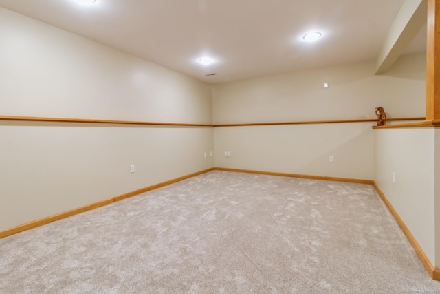 carpeted empty room with baseboards