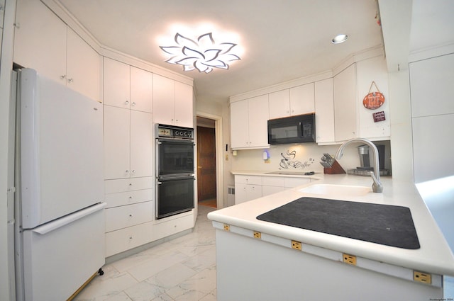 kitchen featuring black appliances, white cabinets, and sink