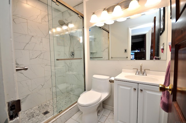 bathroom with vanity, toilet, and a shower with door