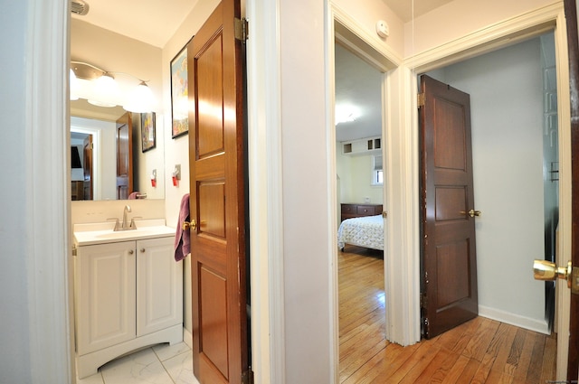 bathroom with vanity and wood-type flooring