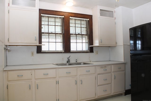 kitchen featuring sink and white cabinets