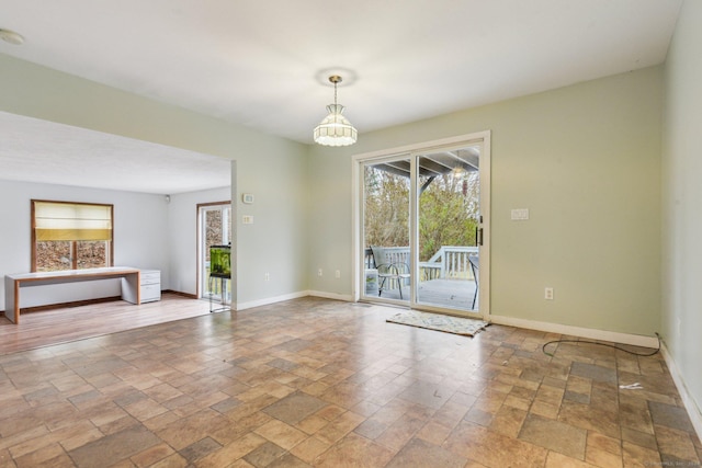empty room featuring a notable chandelier