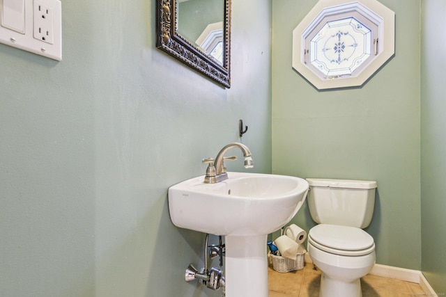 bathroom with tile patterned flooring and toilet
