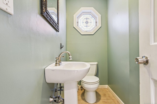 bathroom with toilet and tile patterned floors