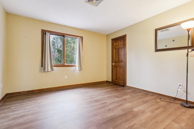 spare room featuring light hardwood / wood-style flooring