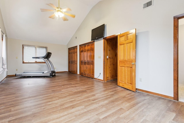 exercise room with ceiling fan, high vaulted ceiling, and light hardwood / wood-style floors