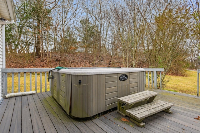deck featuring a lawn and a hot tub