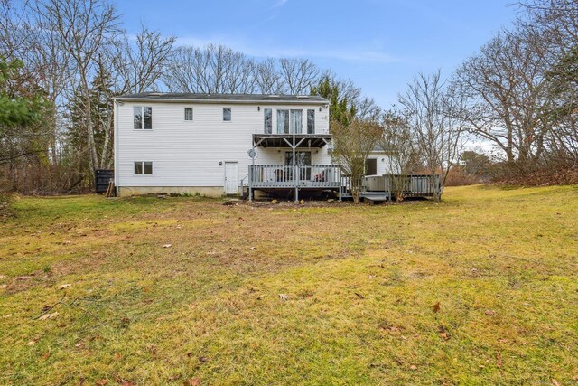 back of property featuring a yard and a deck