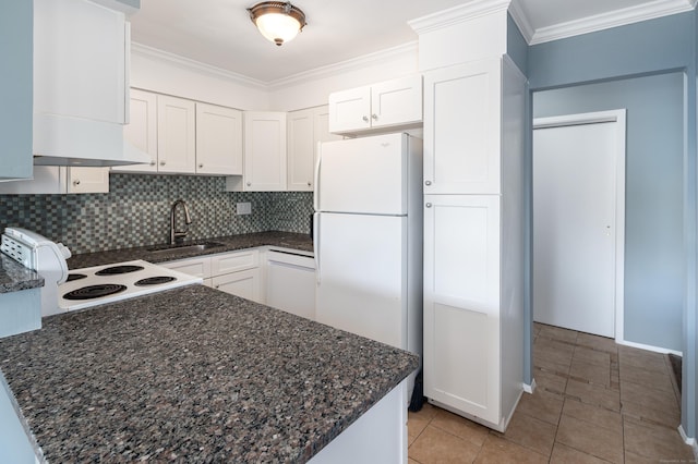 kitchen with light tile patterned floors, decorative backsplash, white appliances, white cabinets, and sink