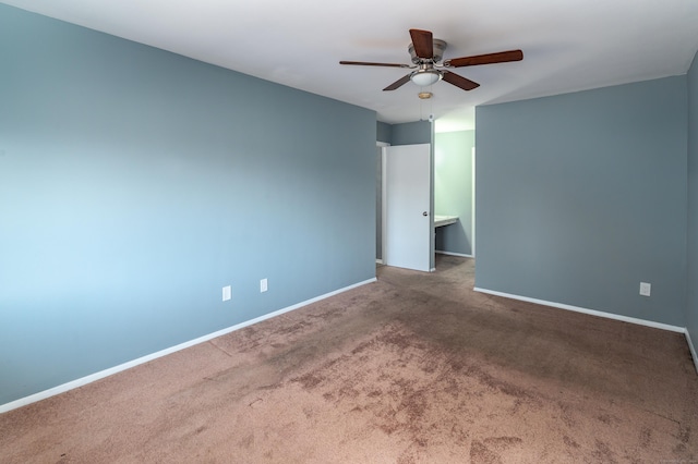 carpeted spare room with ceiling fan