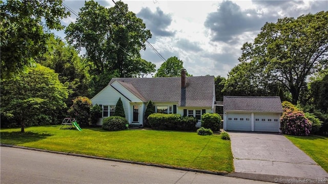 view of front of house featuring a front lawn, an outdoor structure, and a garage