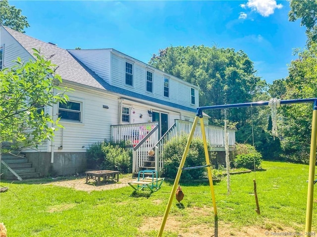 back of house with a yard and a deck