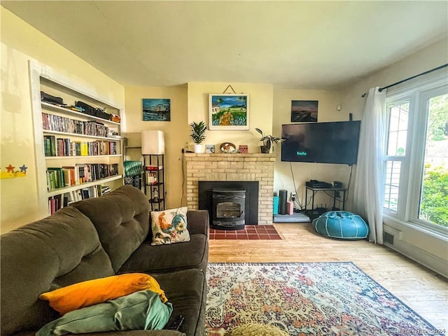 living room featuring hardwood / wood-style flooring and a wood stove