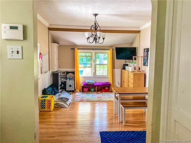 playroom featuring hardwood / wood-style flooring, a notable chandelier, and ornamental molding