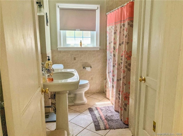 bathroom with walk in shower, tile patterned flooring, tile walls, and toilet