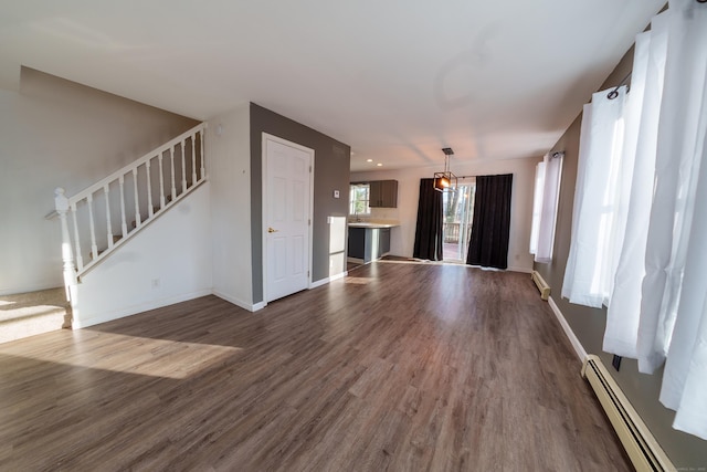 unfurnished living room with dark hardwood / wood-style flooring, sink, and a baseboard radiator