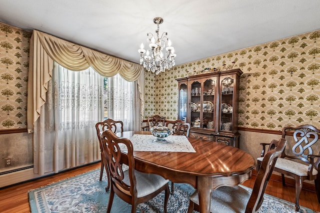 dining room with hardwood / wood-style floors, a chandelier, and a textured ceiling