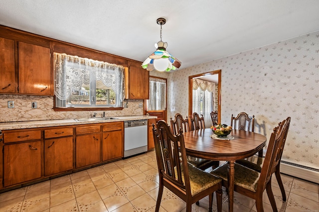 dining room with a textured ceiling, light tile patterned floors, and sink