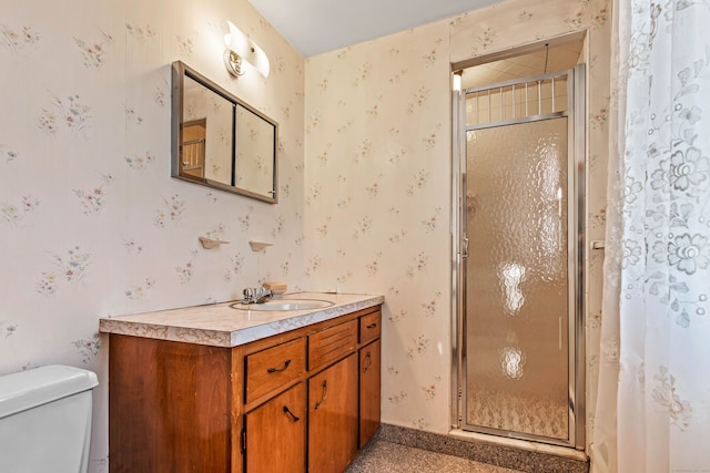 bathroom with vanity, toilet, and walk in shower