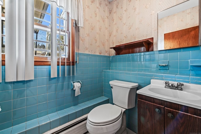 bathroom featuring vanity, toilet, tile walls, and a baseboard radiator