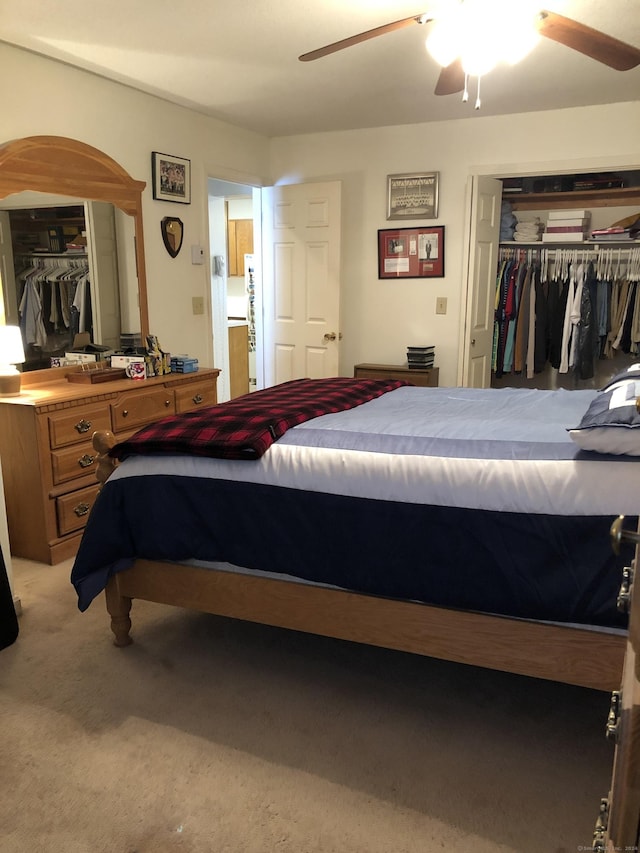 bedroom featuring light colored carpet and ceiling fan