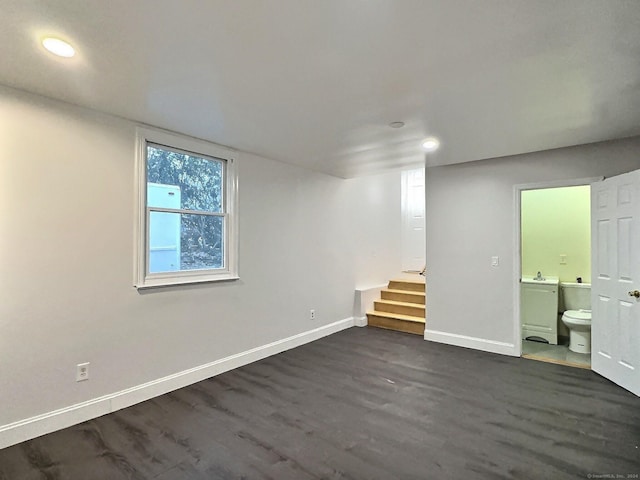 basement with dark hardwood / wood-style floors