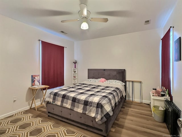 bedroom with ceiling fan and wood-type flooring