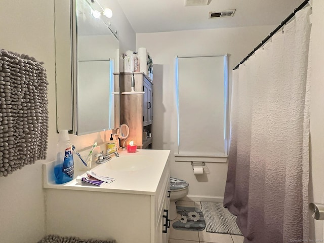 bathroom with tile patterned flooring, vanity, and toilet