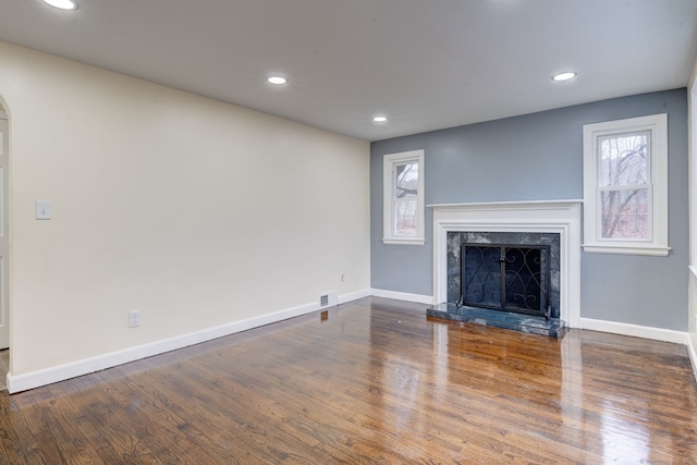 unfurnished living room with a fireplace and dark hardwood / wood-style floors