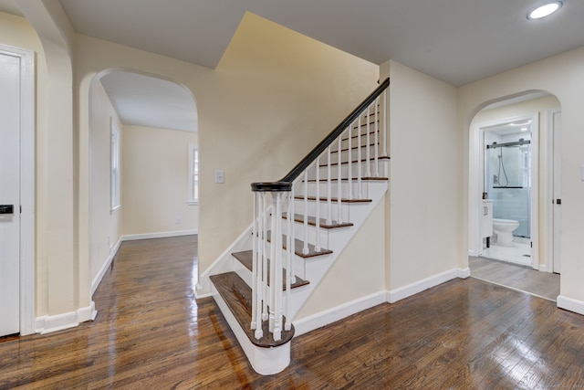 staircase featuring wood-type flooring