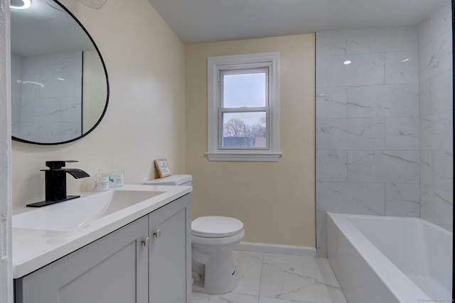 full bathroom featuring tiled shower / bath, vanity, and toilet