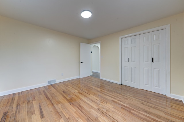 unfurnished bedroom featuring a closet and light hardwood / wood-style flooring