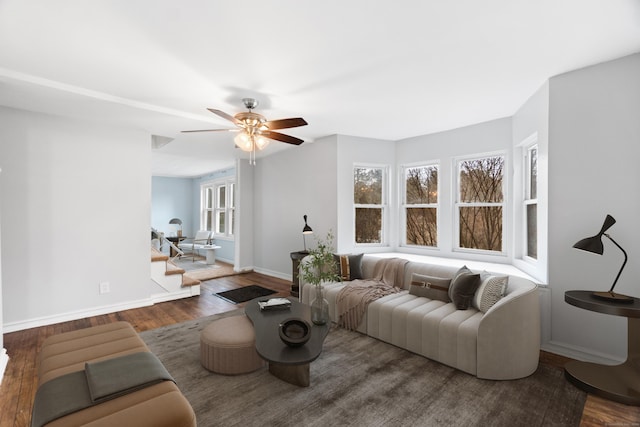 living room with dark hardwood / wood-style floors and ceiling fan