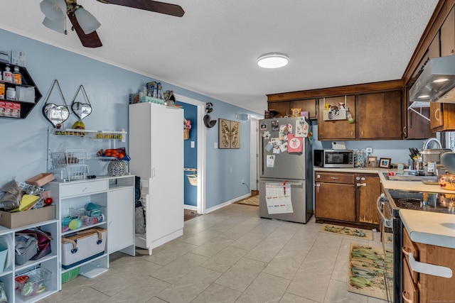 kitchen with ceiling fan, ornamental molding, a textured ceiling, range hood, and stainless steel appliances