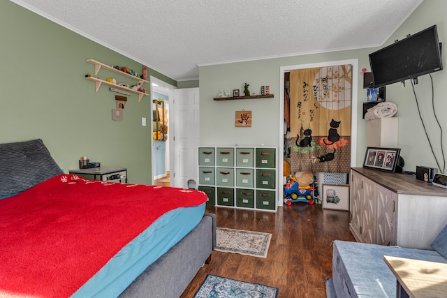 bedroom with crown molding, dark hardwood / wood-style flooring, and a textured ceiling