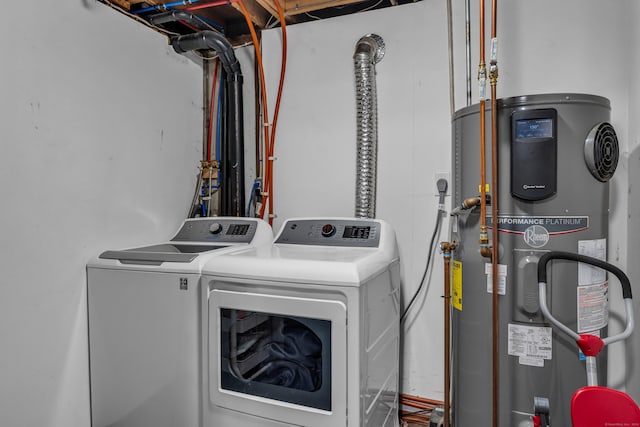 laundry area with washing machine and dryer and heat pump water heater