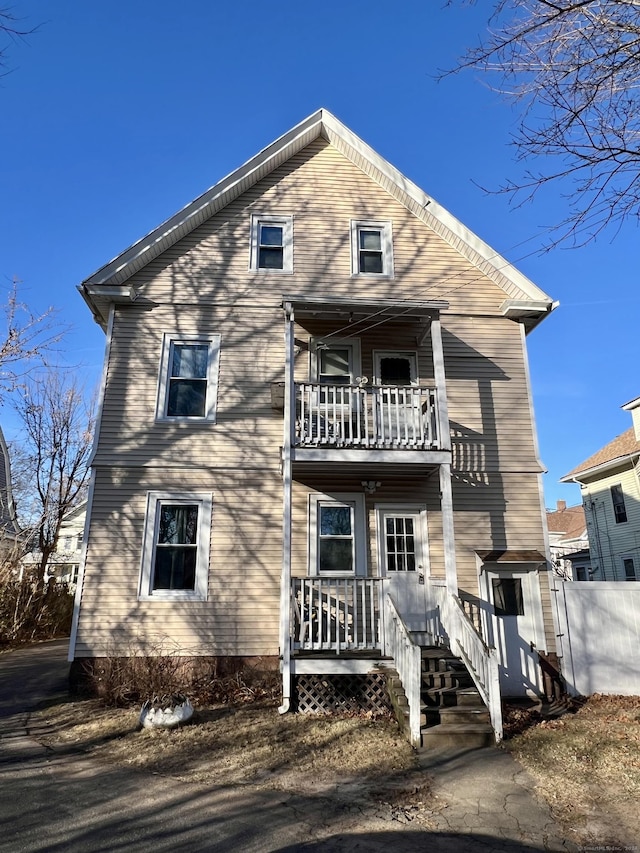 back of house featuring a balcony